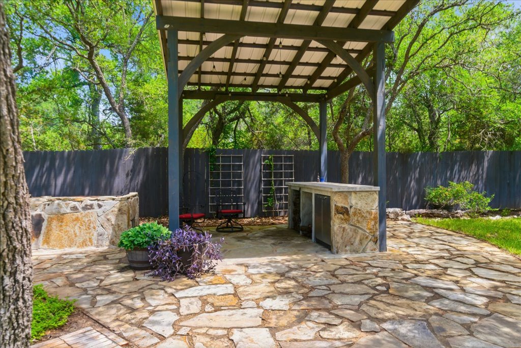 12702 Trails End Road Cedar Park, TX 78641 - Photo 30 of 40 Custom outdoor living area featuring a covered pavilion, built-in counter, and expansive stone patio - perfect for entertaining year-round.