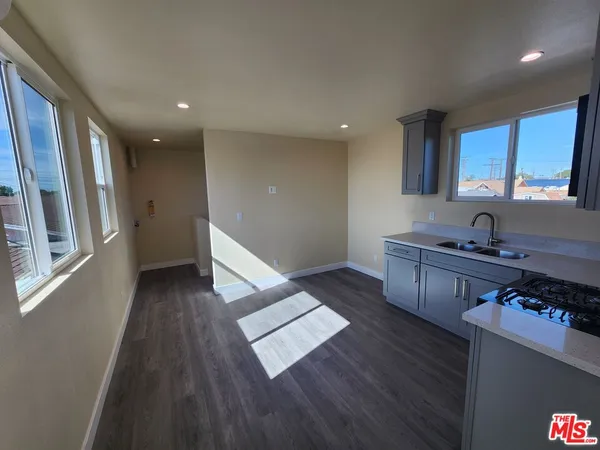 a kitchen with stainless steel appliances granite countertop a stove and a wooden floors