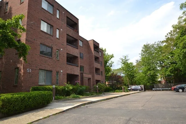 a view of a brick building next to a yard