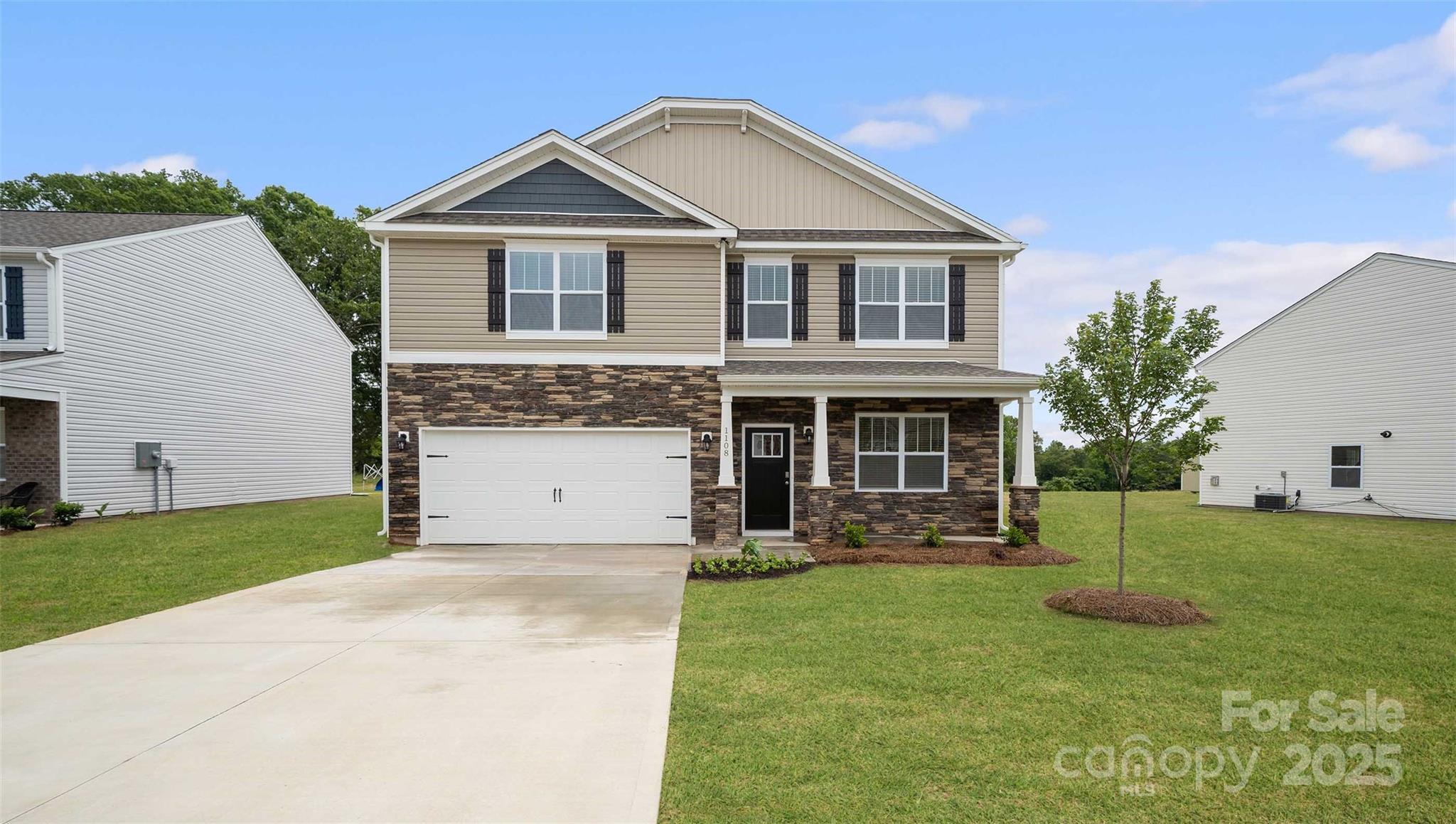 291 Shorthorn Road Fletcher, NC 28732 - Photo 2 of 21 a front view of a house with a garden and plants