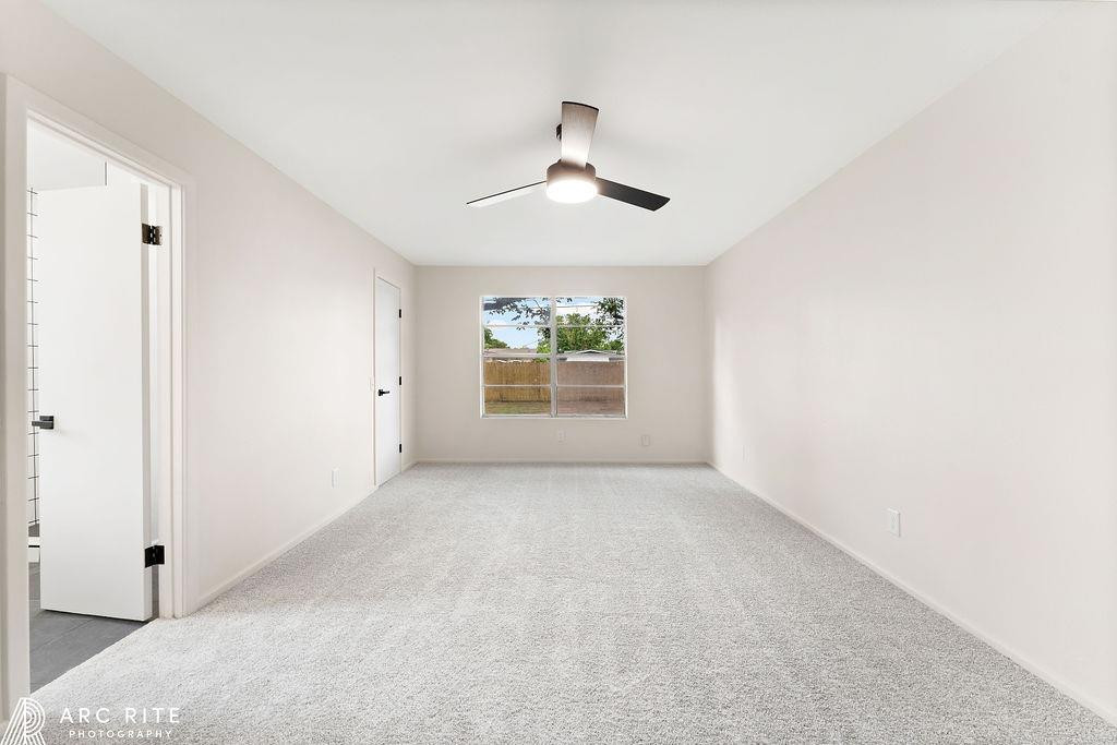 4015 37th Street Lubbock, TX 79413 - Photo 15 of 30 an empty room with windows and chandelier fan