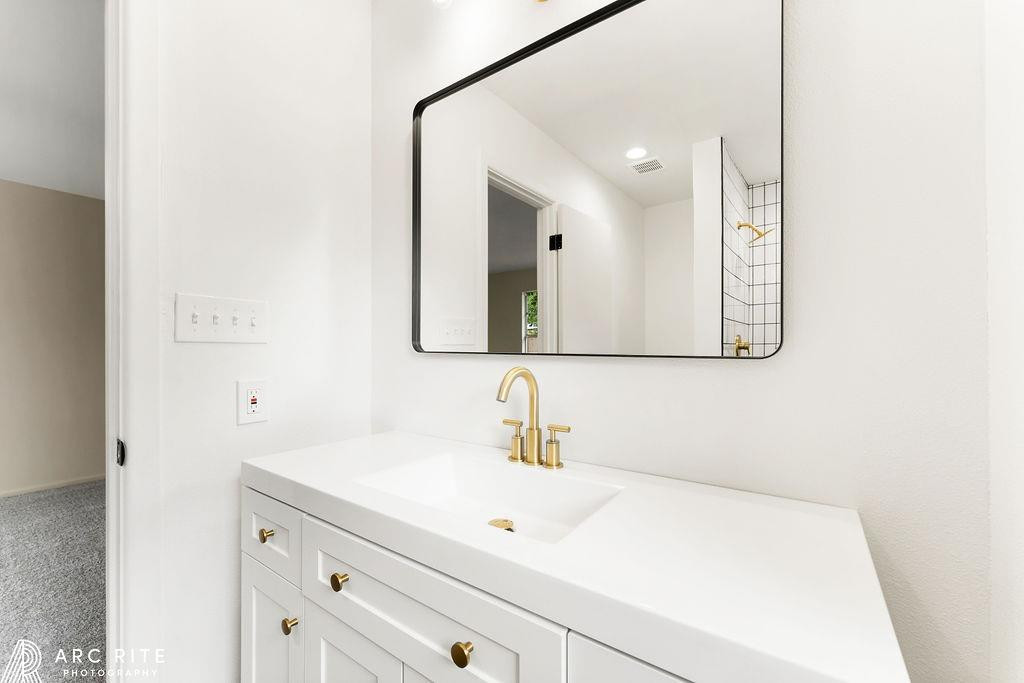 4015 37th Street Lubbock, TX 79413 - Photo 19 of 30 a bathroom with a sink and a mirror