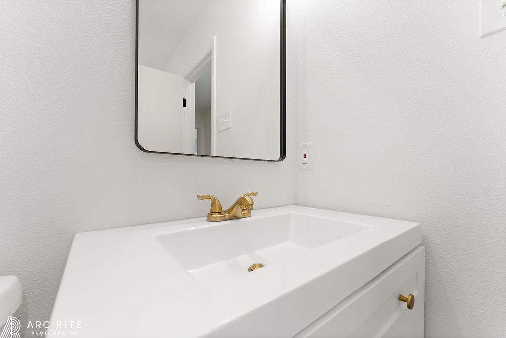 4015 37th Street Lubbock, TX 79413 - Photo 25 of 30 a bathroom with a sink and mirror