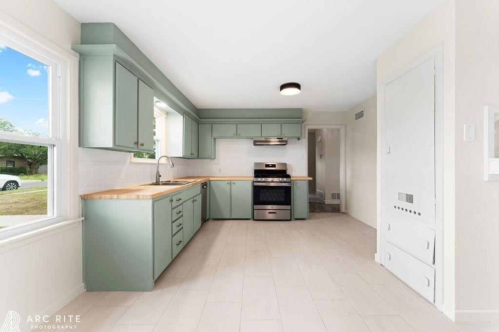 4015 37th Street Lubbock, TX 79413 - Photo 5 of 30 a kitchen with sink cabinets and window