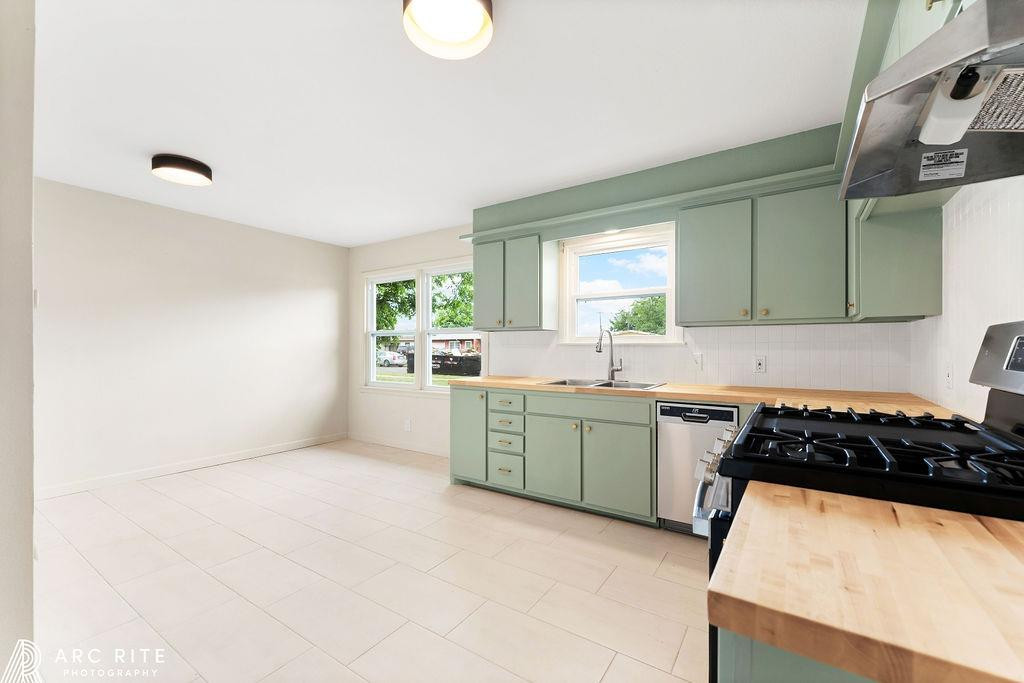 4015 37th Street Lubbock, TX 79413 - Photo 6 of 30 a kitchen with a refrigerator and a sink