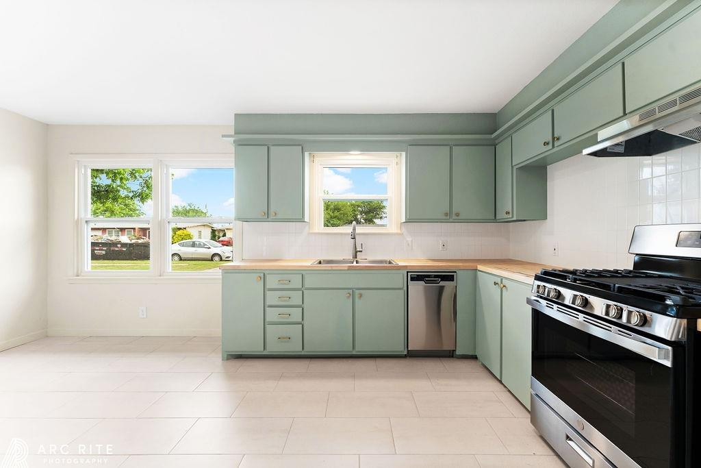 4015 37th Street Lubbock, TX 79413 - Photo 8 of 30 a kitchen with a stove a sink and a window