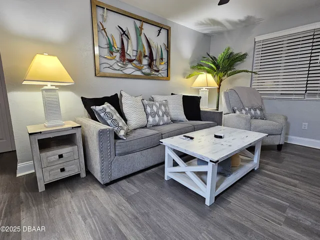 a living room with furniture and a lamp