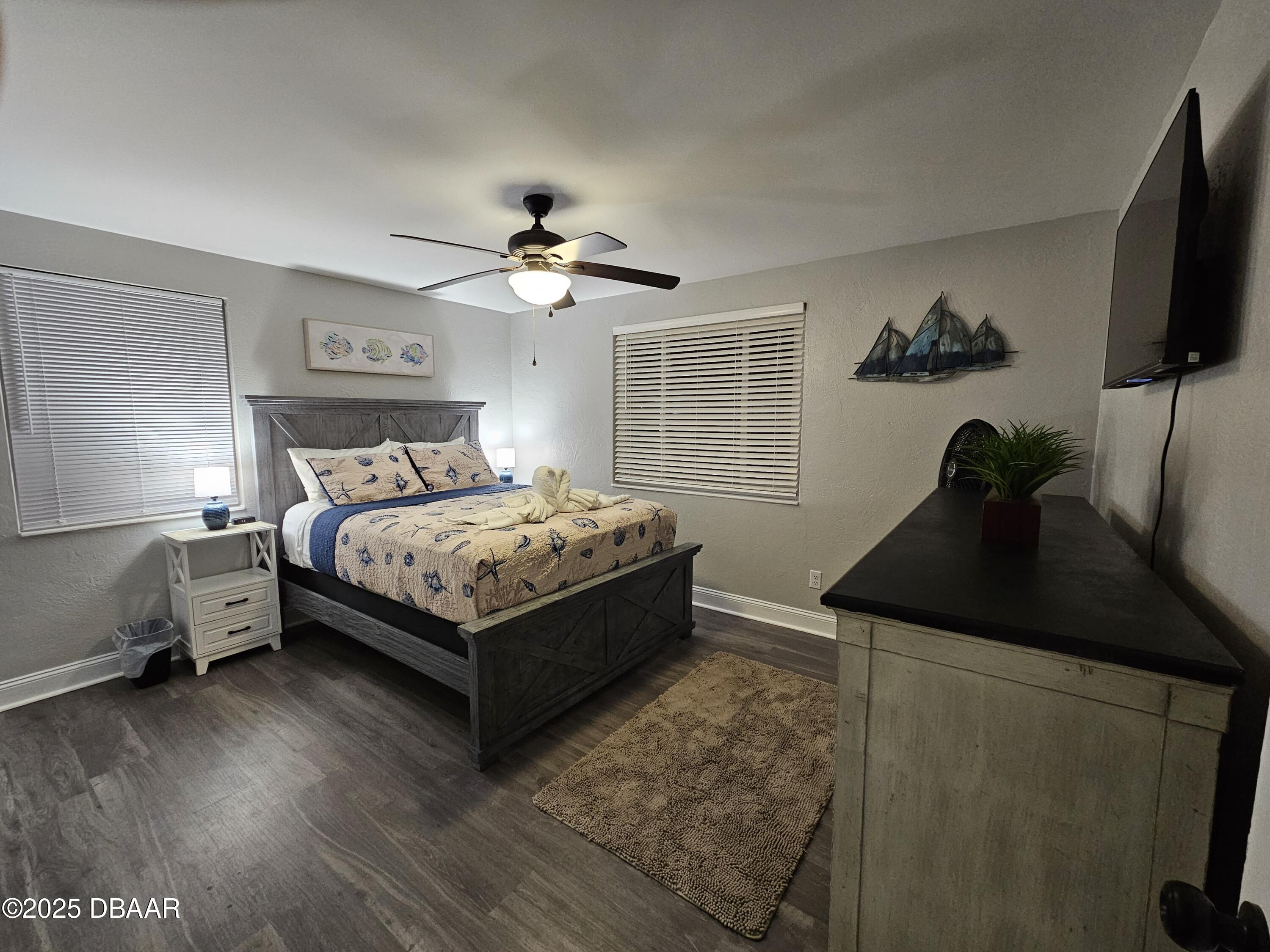 62 Rivershore Drive Ormond Beach, FL 32176 - Photo 15 of 27 a bedroom with a bed potted plant on dresser and a wooden floor