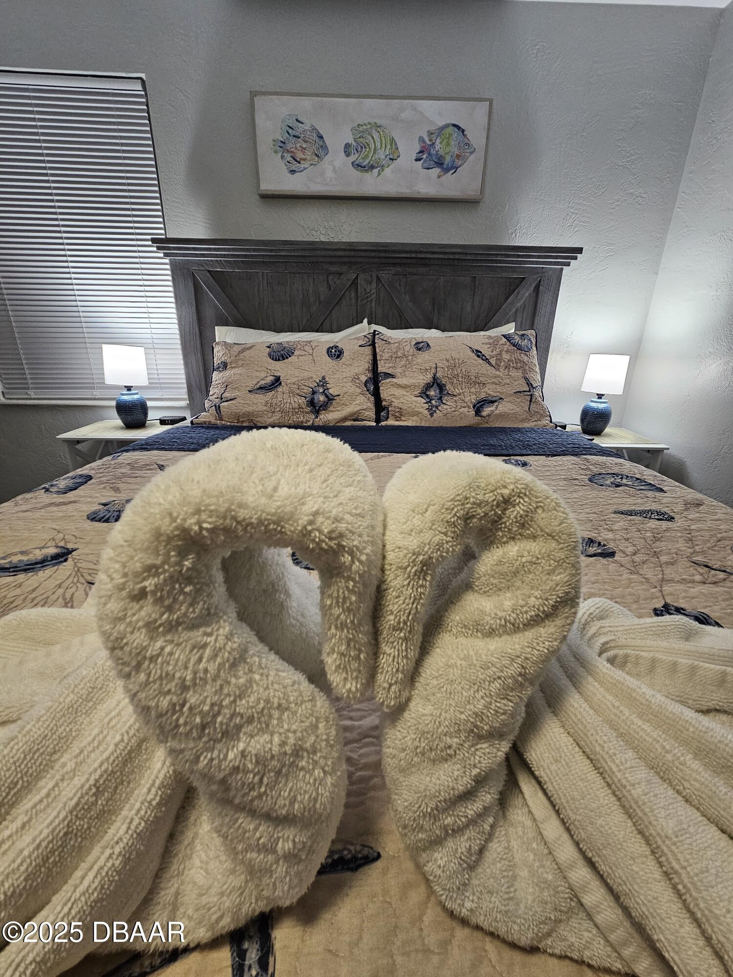62 Rivershore Drive Ormond Beach, FL 32176 - Photo 16 of 27 a bed sitting in a bedroom and table