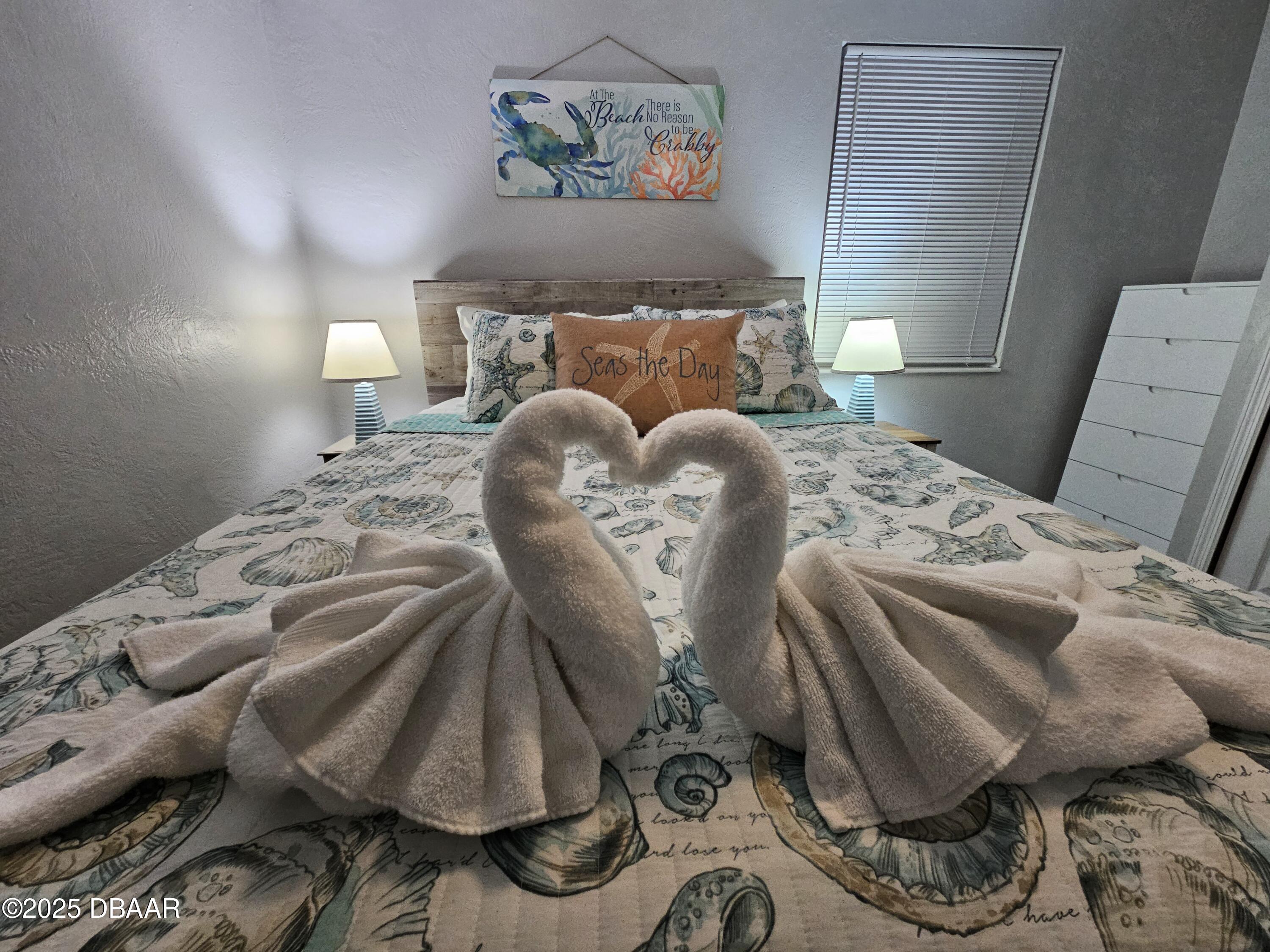 62 Rivershore Drive Ormond Beach, FL 32176 - Photo 19 of 27 a bed with a white comforter and pillows