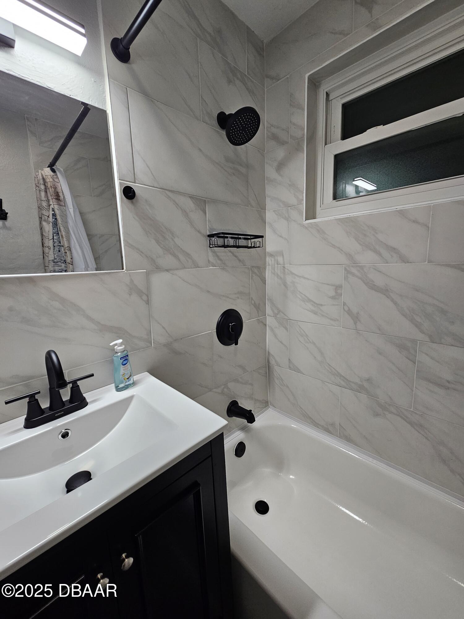62 Rivershore Drive Ormond Beach, FL 32176 - Photo 23 of 27 a bathroom with a tub sink and mirror