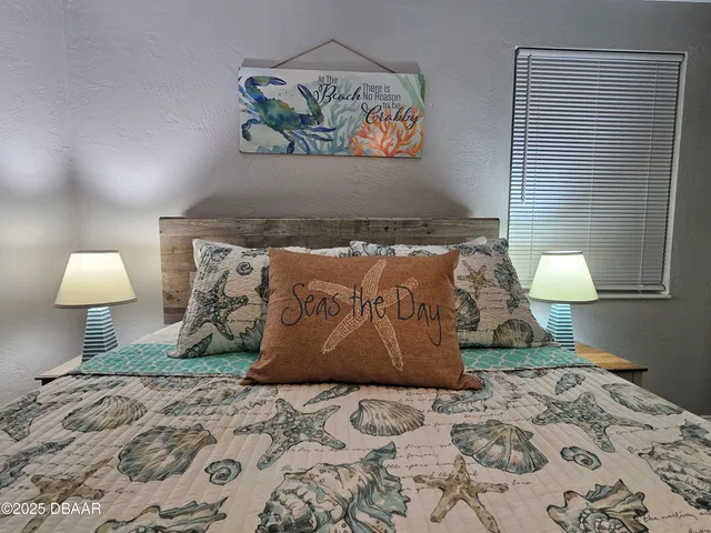 a bedroom with a bed and a lamp