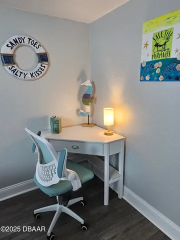a view of a room that has a table and chairs in it