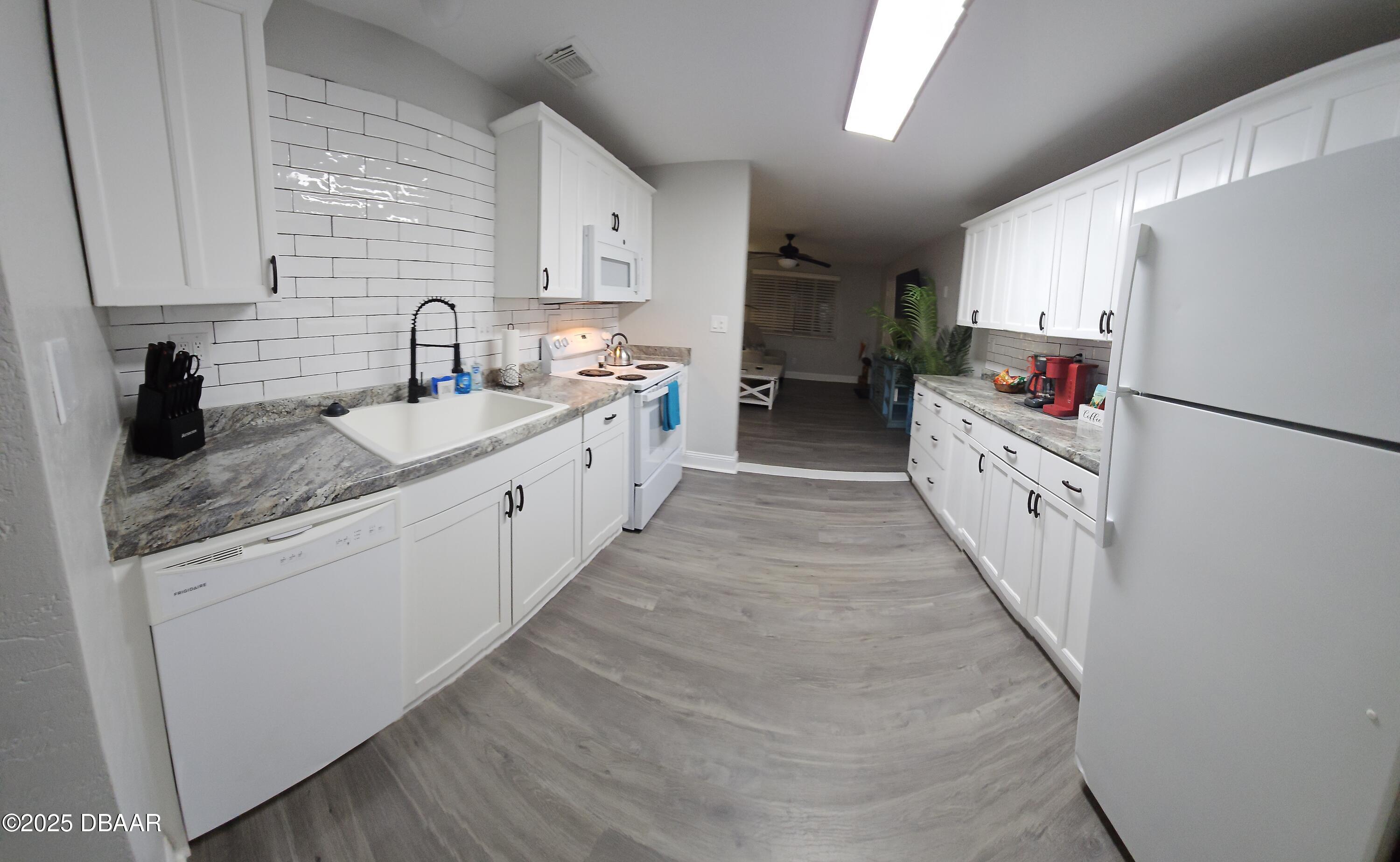 62 Rivershore Drive Ormond Beach, FL 32176 - Photo 6 of 27 a view of a kitchen with sink and refrigerator