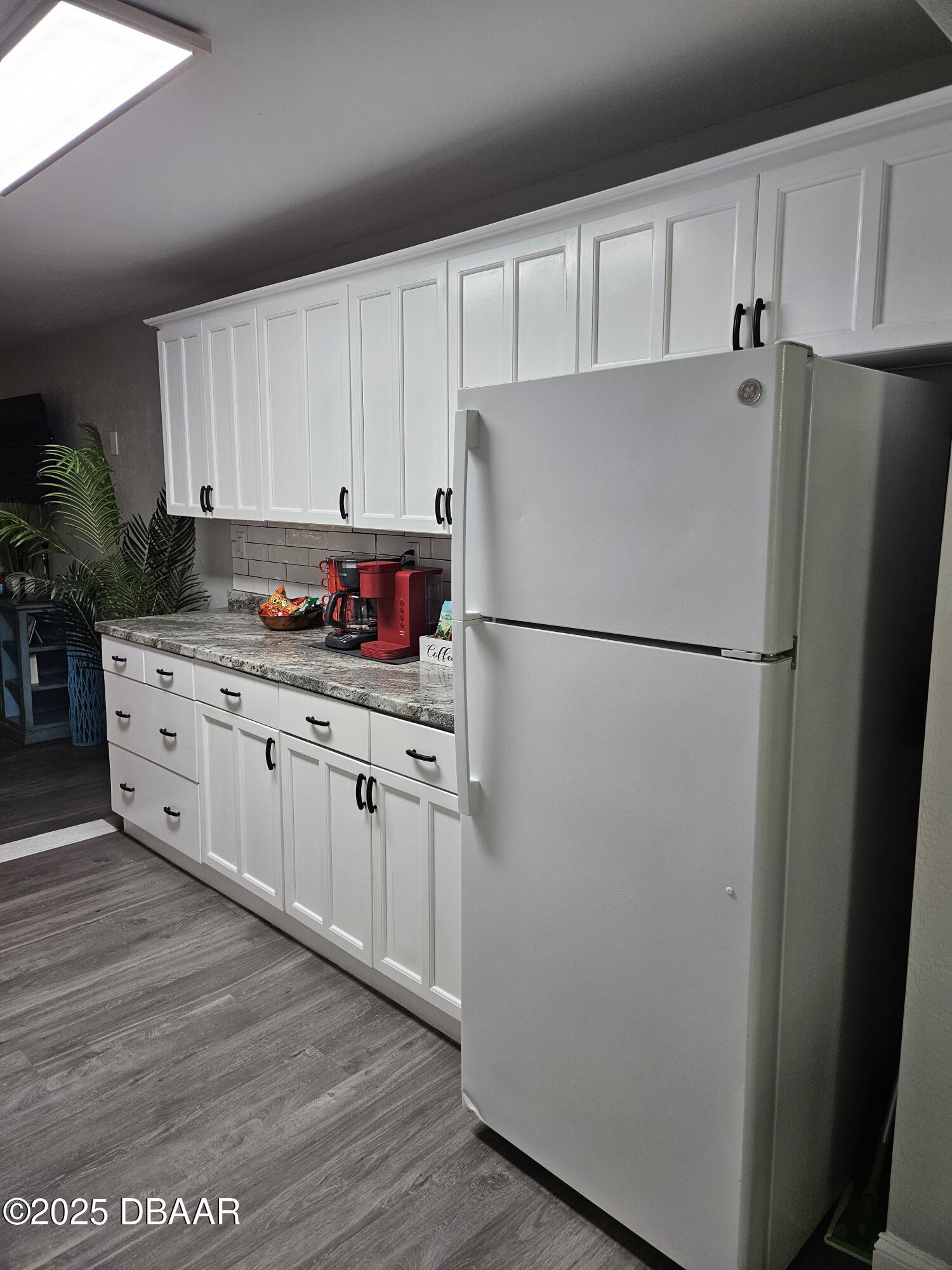 62 Rivershore Drive Ormond Beach, FL 32176 - Photo 8 of 27 a kitchen with stainless steel appliances a refrigerator sink and cabinets