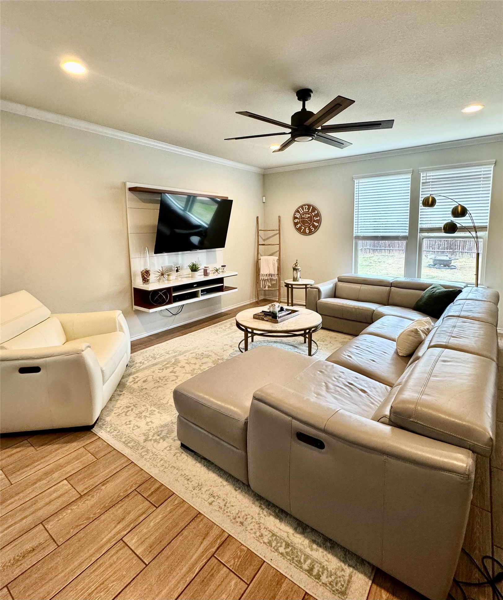 1017 Cliffbrake Way Georgetown, TX 78626 - Photo 6 of 21 Living area featuring wood tiled floors, a ceiling fan, ornamental molding, and recessed lighting