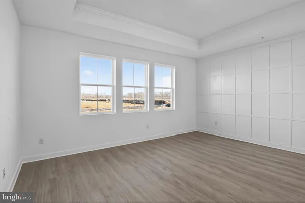 a bathroom with a glass shower door and a window
