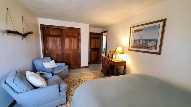 a bedroom with a bed and a book shelf