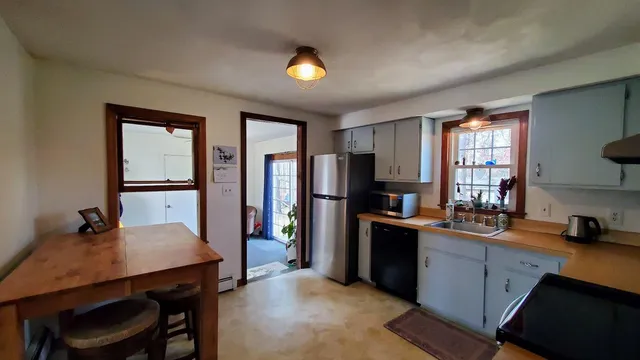 a kitchen with stainless steel appliances a sink stove and refrigerator