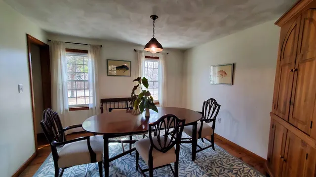a dining room with furniture and window