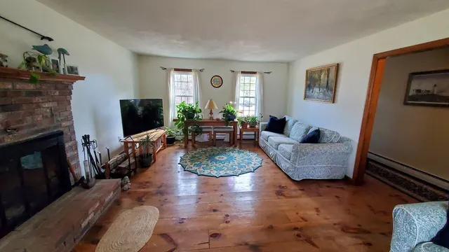 a living room with fireplace furniture and a flat screen tv