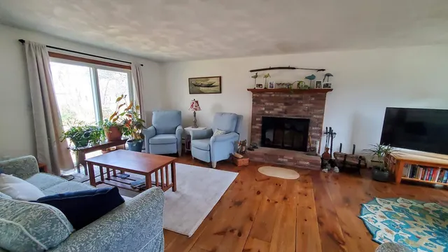a living room with furniture fireplace and flat screen tv