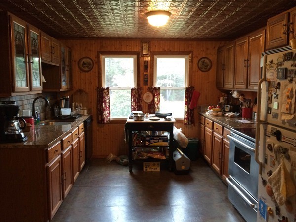17 Searle Road Huntington, MA 01050 - Photo 6 of 19 a kitchen with wooden cabinets and a stove top oven