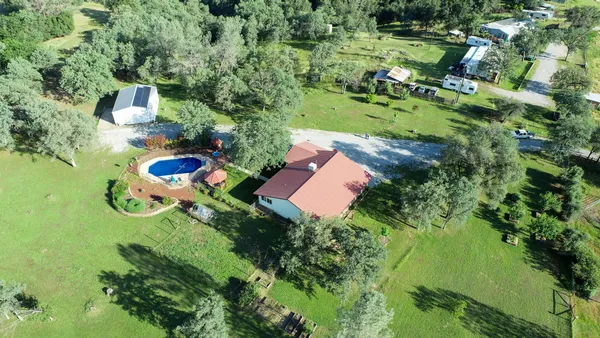 an aerial view of a house with pool yard outdoor seating and yard