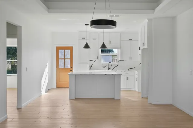 a view of kitchen with sink and wooden floor