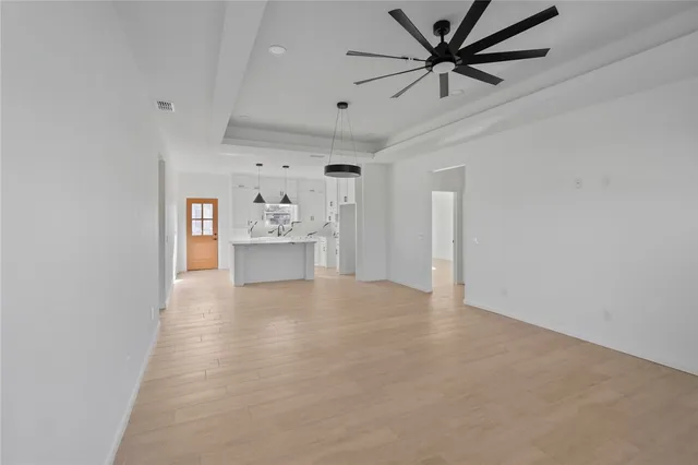 a view of a kitchen with a sink and a refrigerator