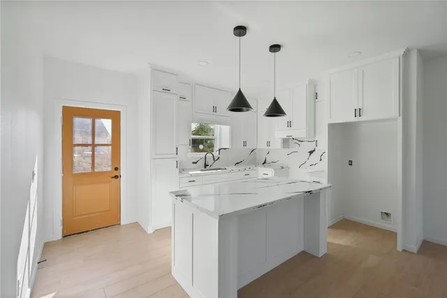 a view of a kitchen with kitchen sink and a window