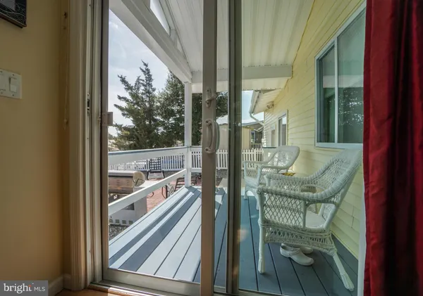 a view of a chairs and table in patio with a lake view