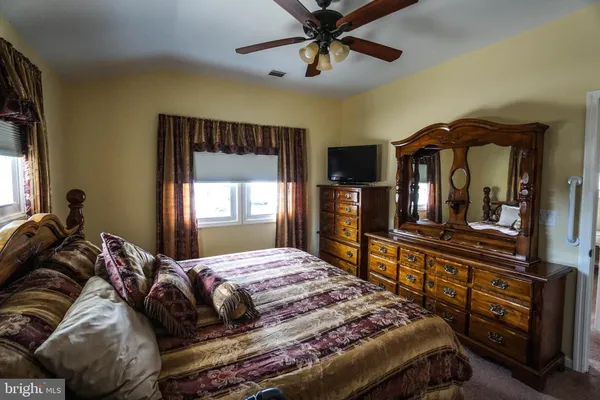 a bedroom with a bed and a mirror