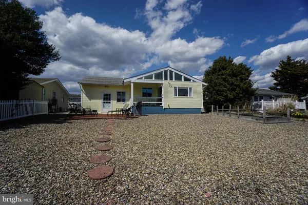 a view of a house with backyard porch and sitting area