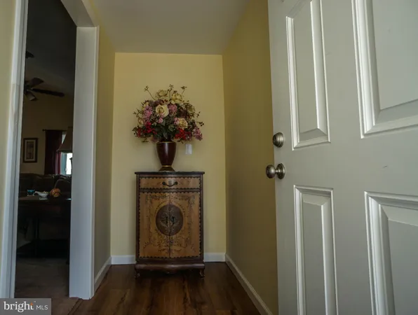 a living room with furniture a ceiling fan and a rug