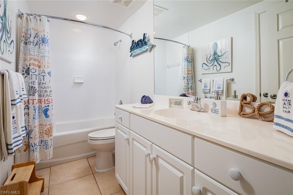 300 Dunes Boulevard, Unit 202 Naples, FL 34110 - Photo 18 of 24 a bathroom with a sink a toilet and shower