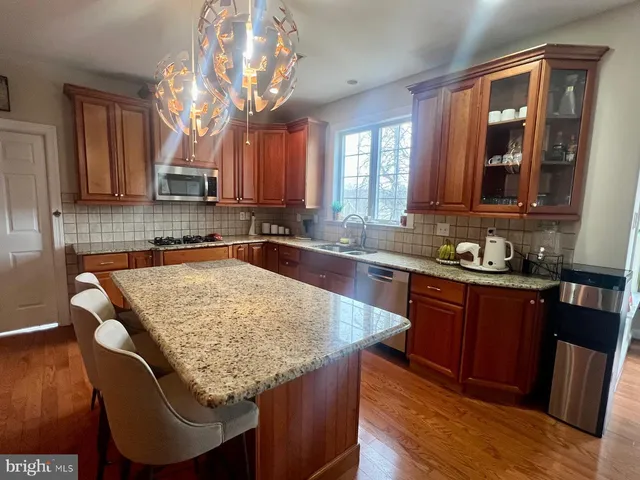 a kitchen with granite countertop sink and cabinets