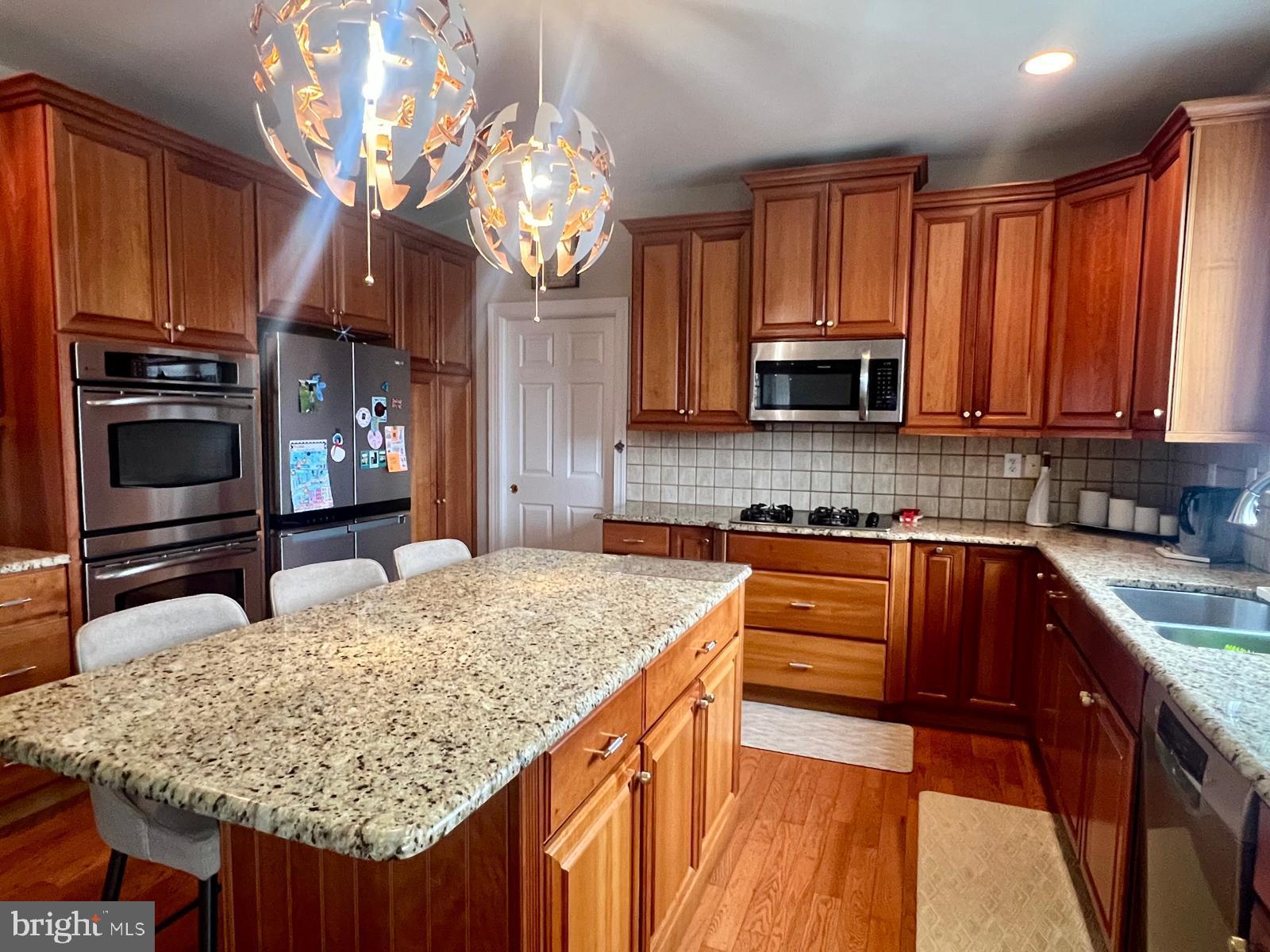 101 Richards Way Avondale, PA 19311 - Photo 16 of 45 a kitchen with stainless steel appliances granite countertop wooden cabinets a stove top oven a sink and dishwasher