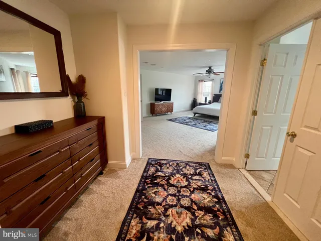 a bedroom with wooden floor and painting on the wall