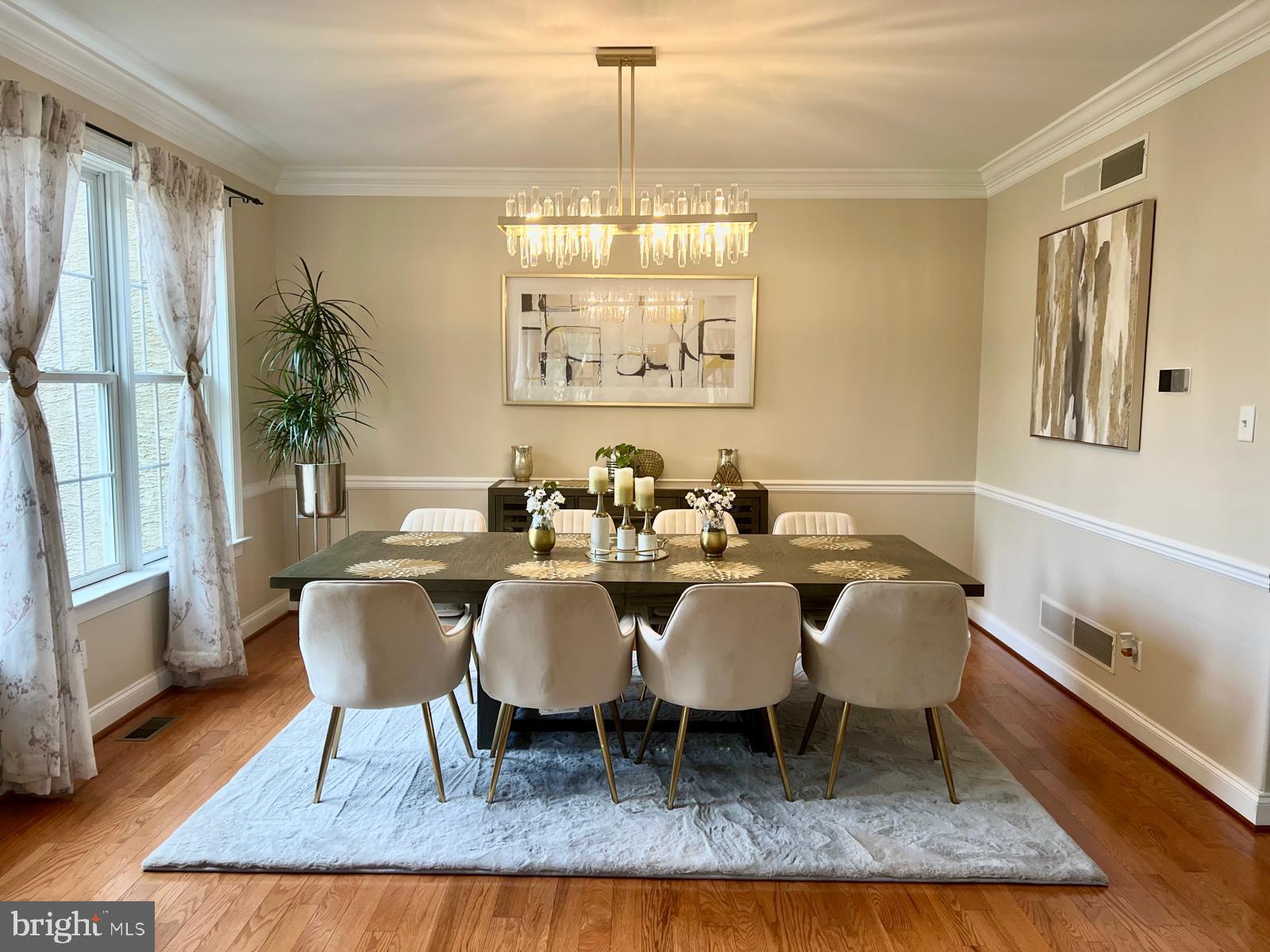 101 Richards Way Avondale, PA 19311 - Photo 3 of 45 a dining room with wooden floor a chandelier a wooden table and chairs