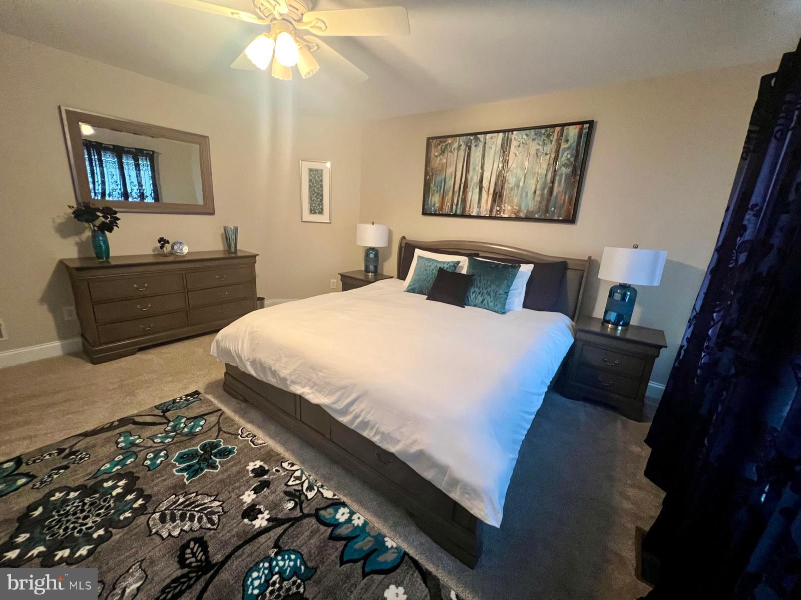 101 Richards Way Avondale, PA 19311 - Photo 37 of 45 a bedroom with a bed mirror and painting on the wall