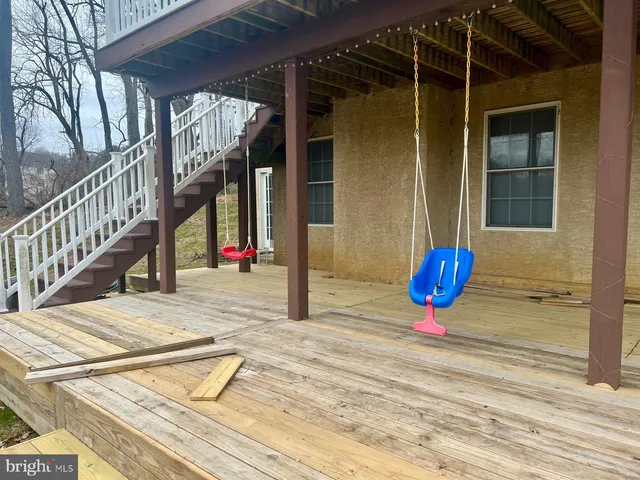 a view of a roof deck with table and chairs and wooden floor