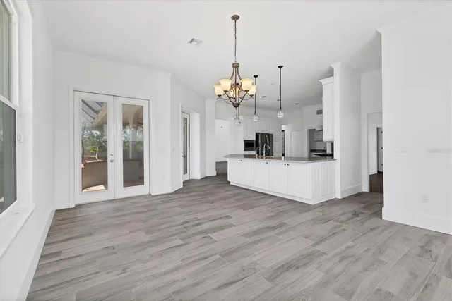 a view of a kitchen with wooden floor and a kitchen