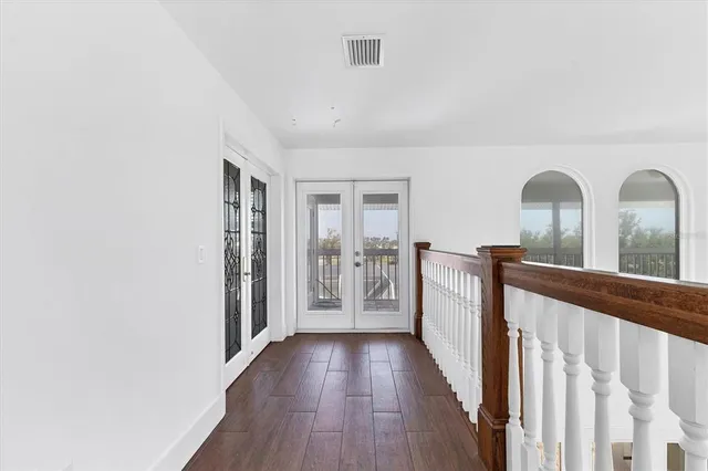 a view of a hallway with wooden floor