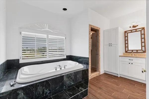 a bathroom with a bathtub and a window