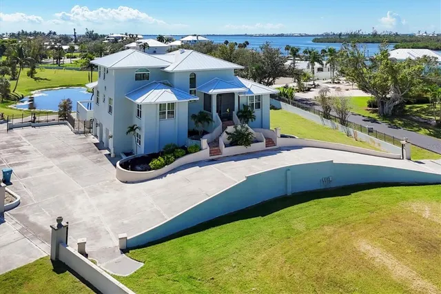 a view of a house with backyard sitting area and garden