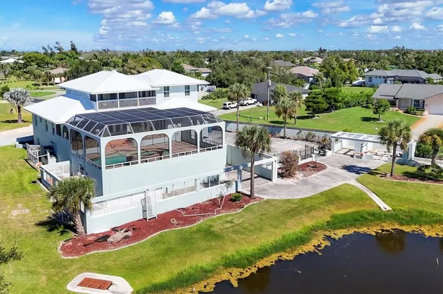 a view of a house with backyard and sitting area