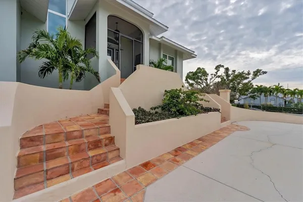 a view of a house with potted plants
