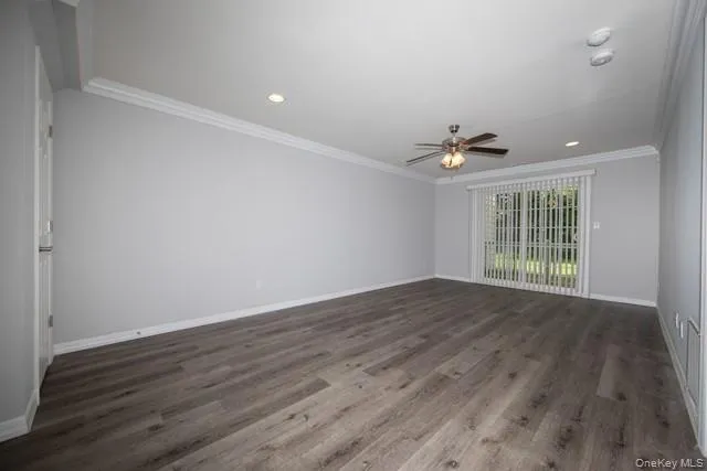 a view of wooden floor and a chandelier fan in a room