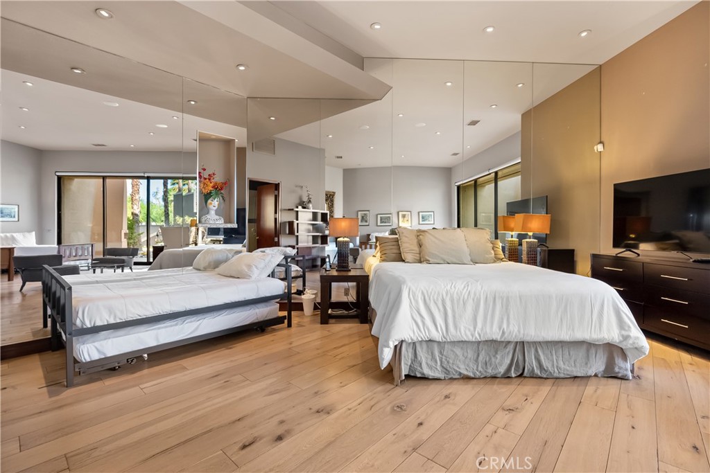 68 Royal St Georges Way Rancho Mirage, CA 92270 - Photo 54 of 75 a large bedroom with a large bed and flat tv screen
